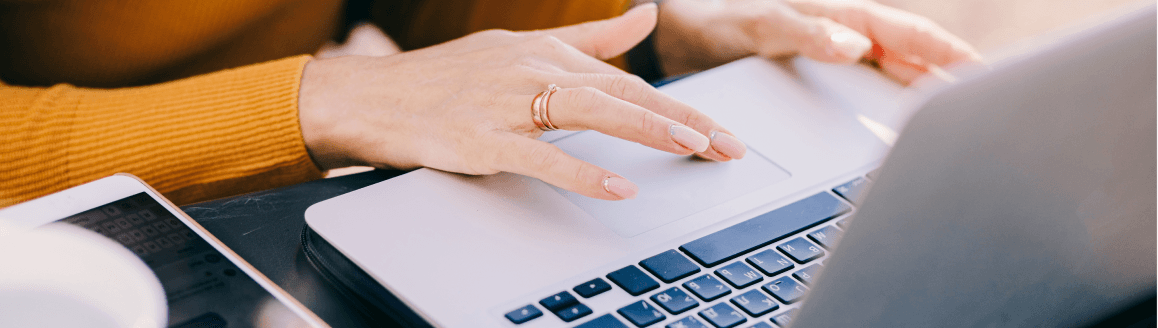 Hands typing on a laptop keyboard